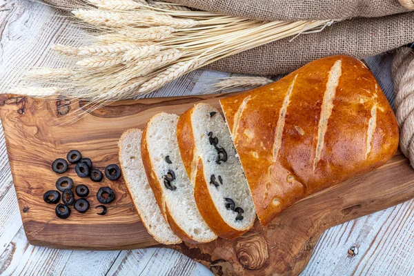 Olive-Rosemary Bread, Italian specialty, isolated on wooden background.