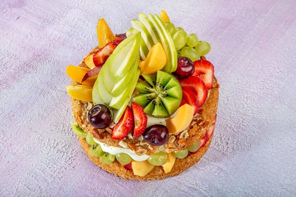 Mixed fruit cake, Fruits pastry pink wooden background.