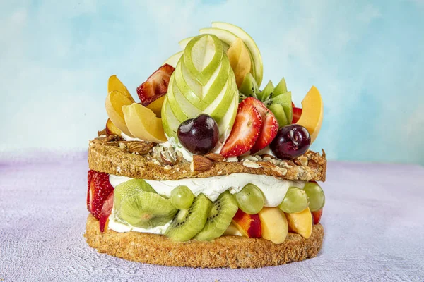 Mixed fruit cake, Fruits pastry pink wooden background.