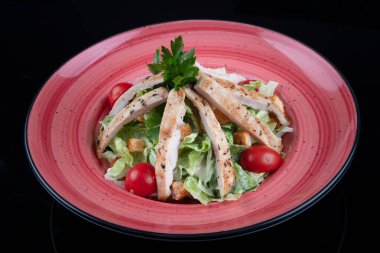 Sağlıklı ızgara tavuklu Sezar salatası ve kızarmış ekmek. Tahta masada taze, sağlıklı sezar salatası pişiyor. Üst görünüm