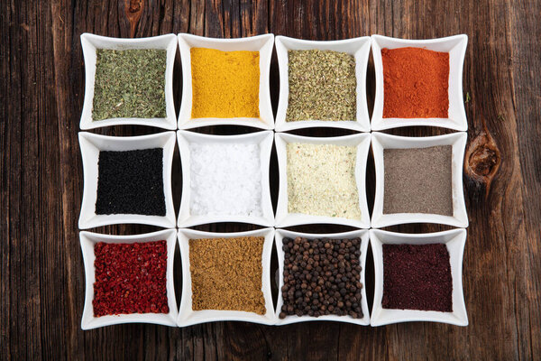 Various spices on wooden background. Top view with copy space.