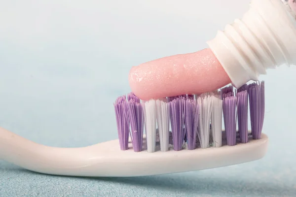 Toothbrush Pink Toothpaste Next Tube Toothpaste Blue Background — Stock Photo, Image