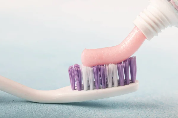 Toothbrush Pink Toothpaste Next Tube Toothpaste Blue Background — Stock Photo, Image