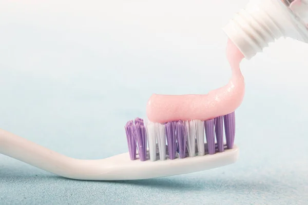 Toothbrush Pink Toothpaste Next Tube Toothpaste Blue Background — Stock Photo, Image