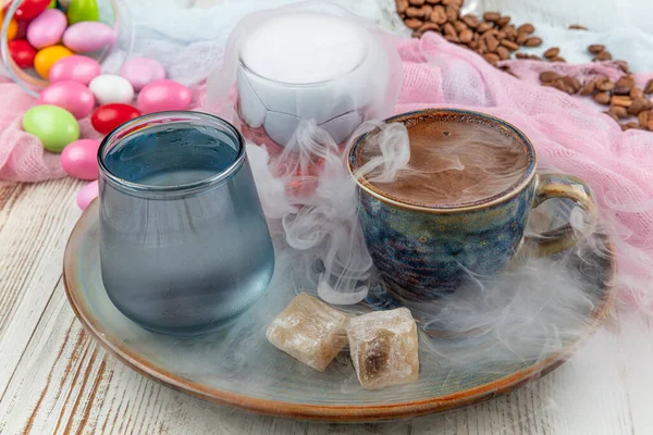 Traditional turkish coffee in porcelain cup set,a glass of water and turkish delight, colorful almond candies on surface with coffee beans. A feast (feast)classic, Ramadan feast catering presentation.