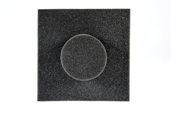 Technical Round Sponge. Black sponge foam in a shape of electronic or computer part, a protective equipment on white background.