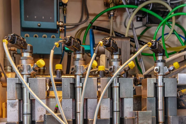 Professional mechanics testing diesel injector in his workshop, repair and diagnostics equipment. testing nozzles for diesel engines, close up