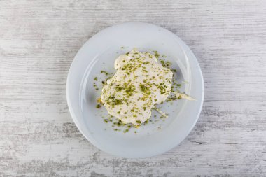 Türk tatlısı, kunafa, kaday fıstığı tozu ve peynirli sıcak yenilen tatlı.