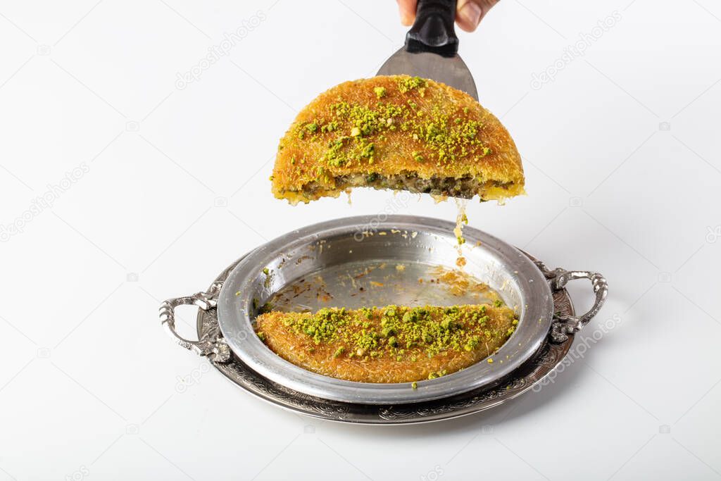 Traditional Turkish Dessert Kunefe (kadayif). Kunefe with cheese. Turkish dessert kunefe, kunafa, kadayif with pistachio powder.