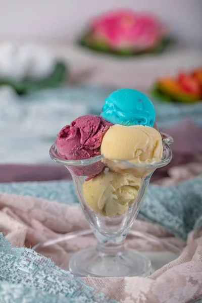 Fruit ice cream. Colorful ice cream balls in bowl with different flavors - mango, lime, mint, pistachio, orange, strawberries, raspberries, blueberries. Summer concept.