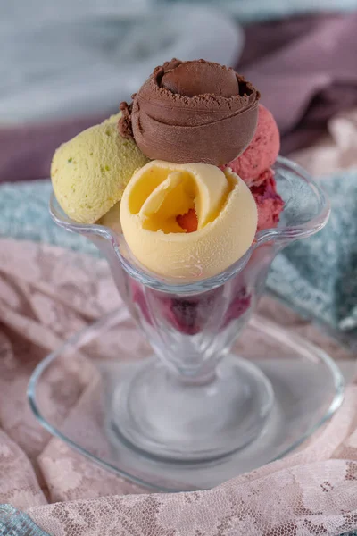 Fruit ice cream. Colorful ice cream balls in bowl with different flavors - mango, lime, mint, pistachio, orange, strawberries, raspberries, blueberries. Summer concept.