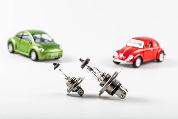 Car Halogen lamp with miniature cars isolated on white background.
