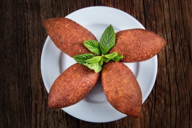 delicious homemade chocolate cake with mint leaves on wooden background