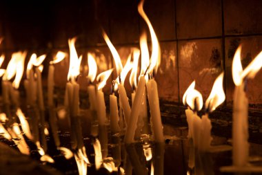 Tapınağı (kilise) ziyaret edin, kürsüdeki mumları yakmak için..