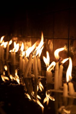 Tapınağı (kilise) ziyaret edin, kürsüdeki mumları yakmak için..