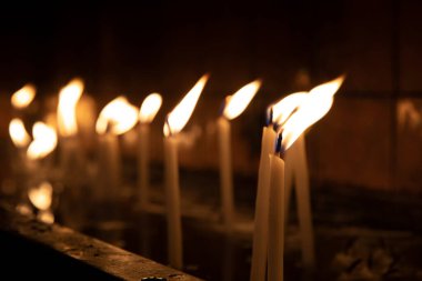 Tapınağı (kilise) ziyaret edin, kürsüdeki mumları yakmak için..