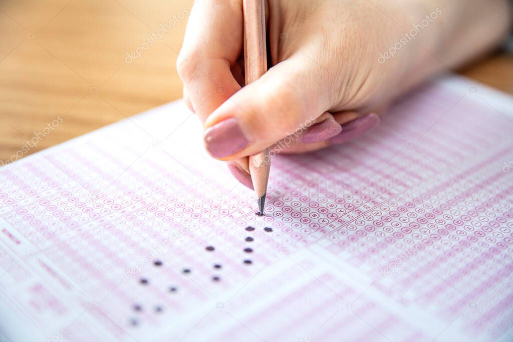 Pencil drawing selected choice on answer sheets. hand fill in Exam carbon paper computer sheet and pencil.