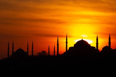 Mavi Cami ve Ayasofya üzerinde gün batımı. İstanbul 'da güneş batarken gökyüzü ve boğaz suları tutuştu 