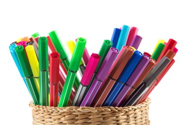 Close-up view of basket with colorful pens