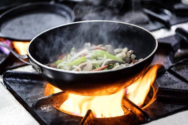 Cooking meat saute. Pieces of meat diced fried in a pan close-up. Stewing beef and vegetables.