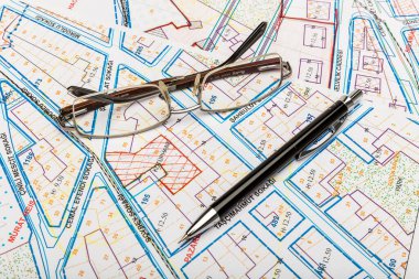 architectural plan of the house with glasses and pen, construction and architecture concept background