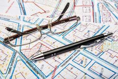 architectural plan of the house with glasses and pen, construction and architecture concept background