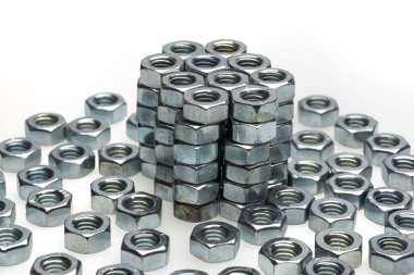 heap of silver screw nuts isolated on white background