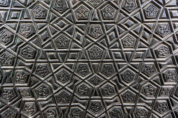 old wooden door with metal pattern