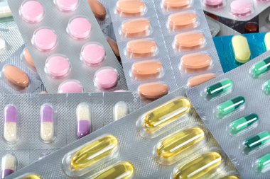 group of different pills in a blister pack on a white background