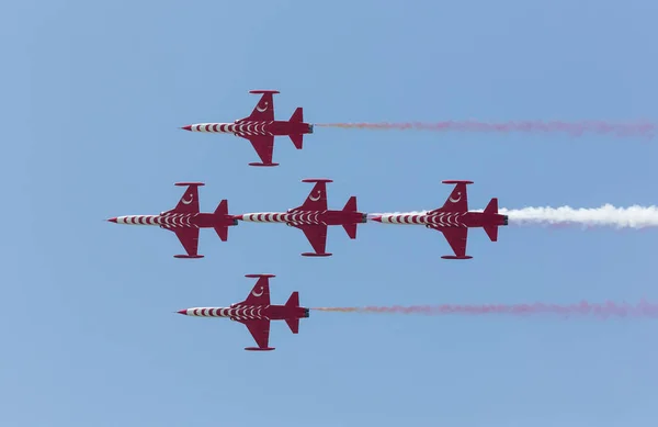 the red and white planes in the sky