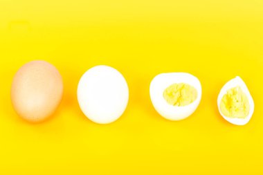 sliced fresh white egg on a yellow background