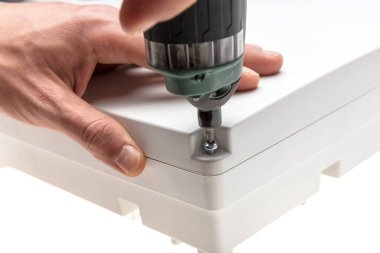 close-up of a hand of a man working with a drill