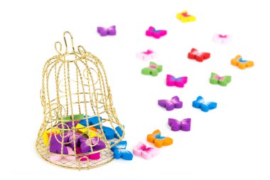 small golden cage with colorful butterfly beads, background for the greeting 