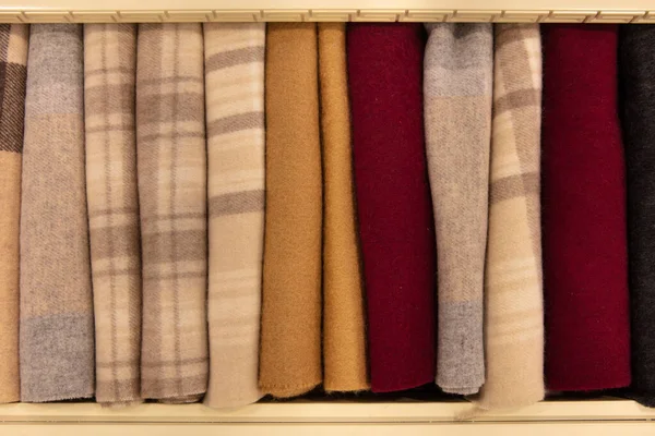 Cashmere wool scarves and wraps with lines and square decoration on a market stall