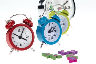 alarm clock and clocks on white background