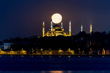 The full moon over Hagia Sophia is officially the Hagia Sophia Grand Mosque in Istanbul, Turkey.