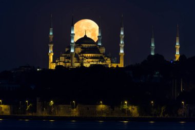 The full moon over Hagia Sophia is officially the Hagia Sophia Grand Mosque in Istanbul, Turkey.