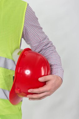 Mühendislik yönetimi inşaatı, mühendis güvenlik miğferi, işçi güvenliği için çalışma alanı arka planında. Busine konsepti. Gri arkaplanda kopyalama alanı olan miğfer tutan inşaat işçisi
