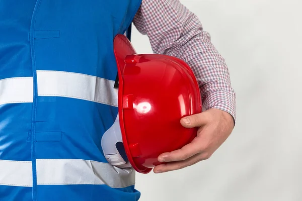 engineering management construction ,engineer hold in hand safety helmet for workers security on working site background. busines concept. construction worker holding helmet on gray background with copy space