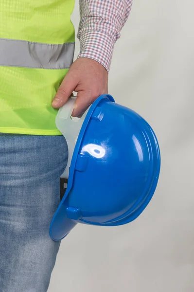 engineering management construction ,engineer hold in hand safety helmet for workers security on working site background. busines concept. construction worker holding helmet on gray background with copy space