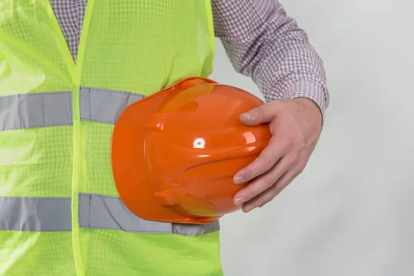 engineering management construction ,engineer hold in hand safety helmet for workers security on working site background. busines concept. construction worker holding helmet on gray background with copy space