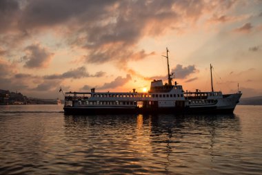 beautiful sunset with the silhouette of a ferry boat on Bosphorus bay 