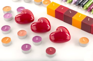 colorful candles in the form of hearts on a white background.