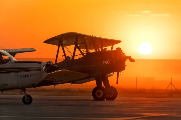 vintage airplane in the airport during sunset