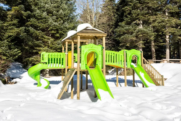 snow covered children playground in the park