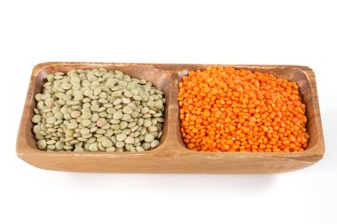 Beyaz arka planda ahşap kasede kırmızı mercimek