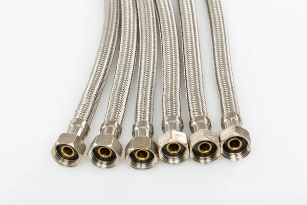 Flexible connection hoses. Hoses for connecting plumbing. Plumbing work in construction isolated on a white background.