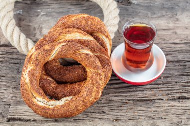 Kahvaltı için ahşap zemin üzerinde Türk Simit 'i. Türk simidi (simit, gevrek) ve çay. 