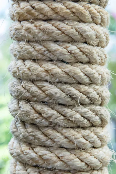 The close up image of twisted natural Linen rope. Natural jute rope, vegetable fiber woven into a thick thread close-up textured effect. Natural plant material. Hemp or linen rope.