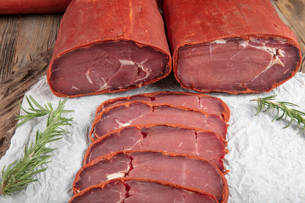 Traditional Turkish Sliced, Dry Aged Meat, Pastirma,Turkish bacon pastrami on wooden board. 